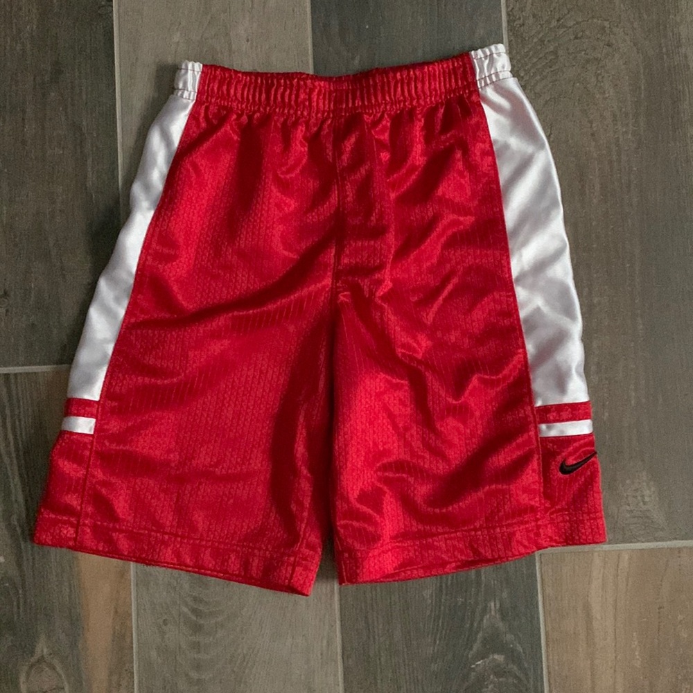 Red and white boys or girls basketball shorts. These shorts can be unisex.